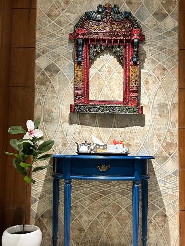 a blue dressing table with a mirror on a wall at Vaydantaa - Luxury Boutique Resort Mussoorie in Mussoorie