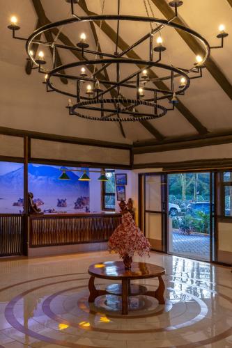 a large room with a table and a chandelier at Naivasha Crescent Lodge in Naivasha