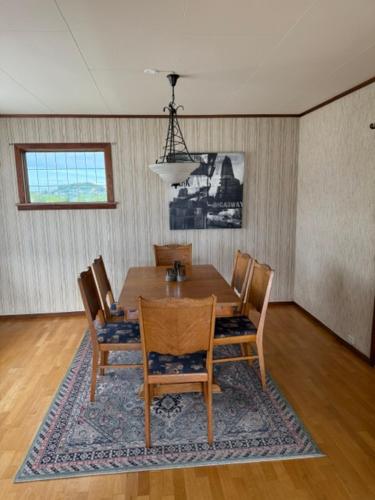 a dining room with a table and chairs at Sunde Fjord view, easy and cheap! in Sula