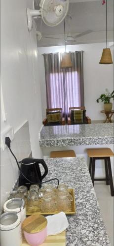 a kitchen with a counter with jars on a table at Vi-ki guest house in Dimapur