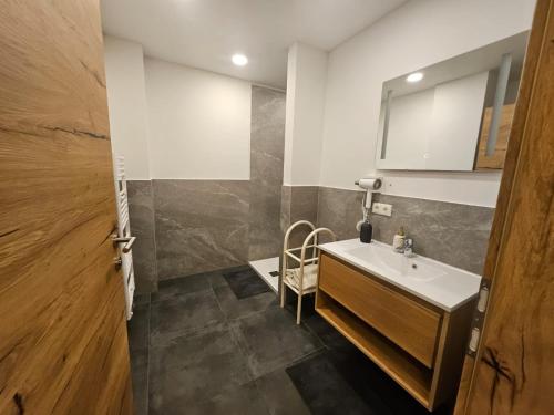 a bathroom with a sink and a mirror at Gasthaus Eichholzer in Murau
