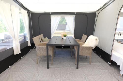 a dining room with a table and chairs in a tent at Topcamp Bogstad - Oslo in Oslo