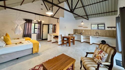 a large room with a bed and a kitchen at Roy's Rest Camp in Groutfontein