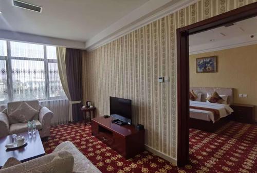 a hotel room with a bed and a couch at Kohi Afsaron in Dushanbe