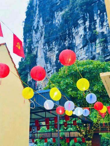 a bunch of colorful umbrellas hanging above a building at Tràng An Sunny River Homestay in Ninh Binh