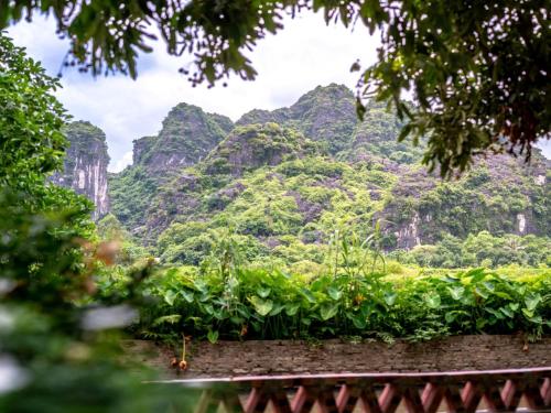 a view of the mountains from a garden at Tràng An Sunny River Homestay in Ninh Binh