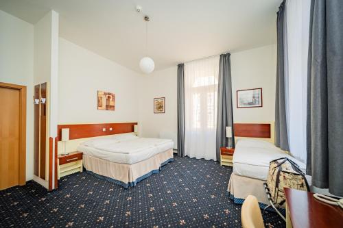 a hospital room with two beds in it at Hotel Atos in Prague