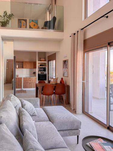 a living room with a couch and a table at Evilion Island Residence in Ixia