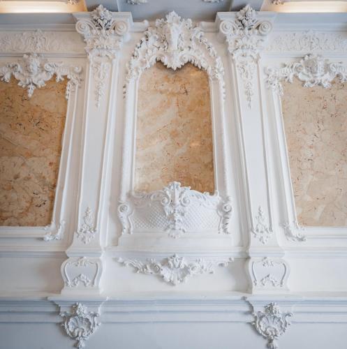 a white wall with two windows in a room at Hotel Atos in Prague