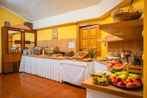 a kitchen with a counter with fruits and vegetables on it at Hotel Atos in Prague