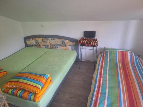a bedroom with two beds with colorful blankets at Apartmani Raft in Foča