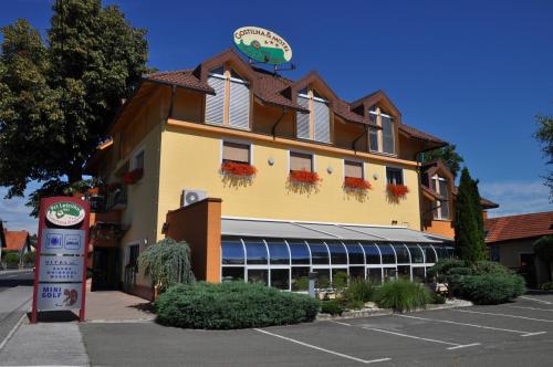 a building with a sign in front of a parking lot at Gostilna in motel Pri Lešniku in Maribor