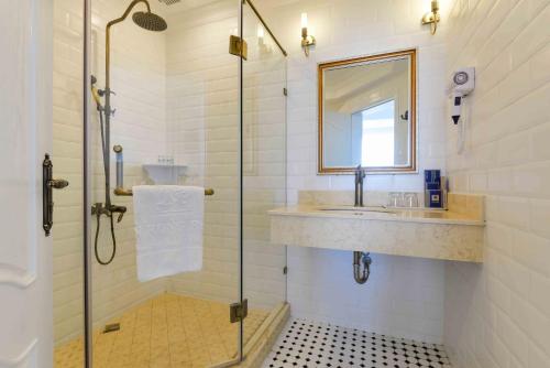 a bathroom with a shower and a sink at Lan Rung Beach Resort in Long Hai
