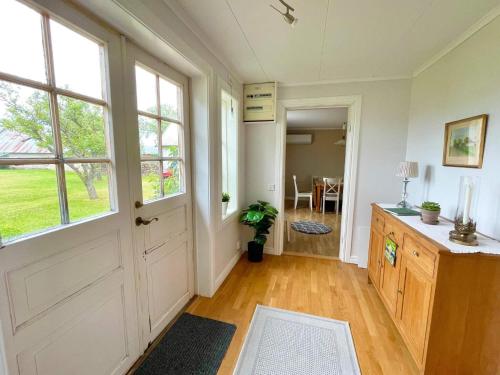 a hallway with a door and windows and a table at 4 star holiday home in KÖPINGSVIK in Köpingsvik