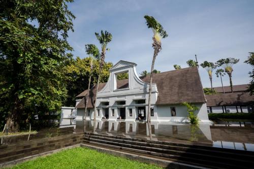 a house is surrounded by flood water at Novotel Bogor Golf Resort in Bogor