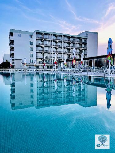 a hotel with a pool of water in front of a building at Hotel Carmen Azzuro in Venus