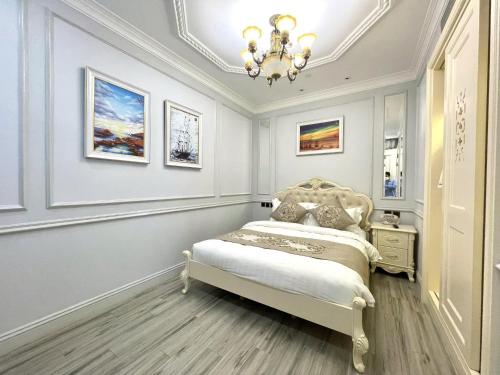a bedroom with a bed and a chandelier at Lan Rung Beach Resort in Long Hai