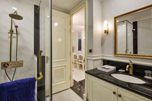 a bathroom with a sink and a mirror at Lan Rung Beach Resort in Long Hai
