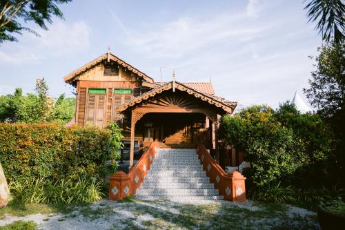 a stairway leading to a wooden building with a bridge at KLIA Transit Homestay Tun Fatimah in Banting