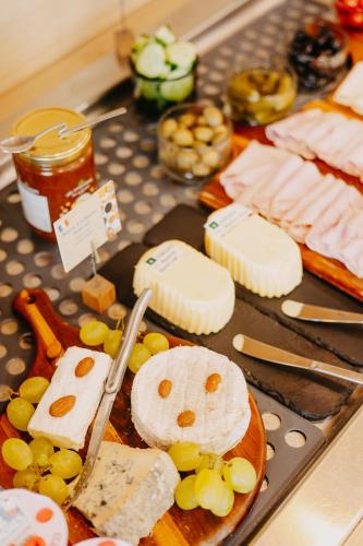 a tray of cheese and meats on a table at Residhome Nanterre La Défense in Nanterre