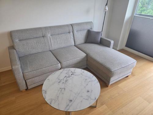 a living room with a couch and a marble table at Spacious and cozy apartment in Tartu in Tartu