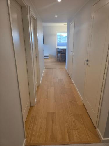 a hallway with white walls and a wooden floor at Spacious and cozy apartment in Tartu in Tartu