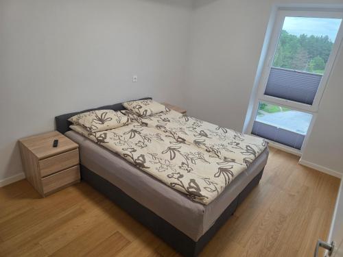 a small bed in a room with a window at Spacious and cozy apartment in Tartu in Tartu