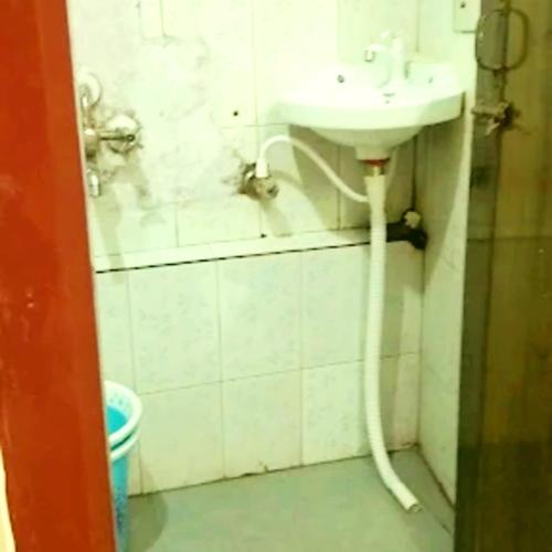 a bathroom with a sink and a toilet at Hotel Pine City in Shillong