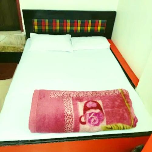 a bed in a room with at Hotel Pine City in Shillong