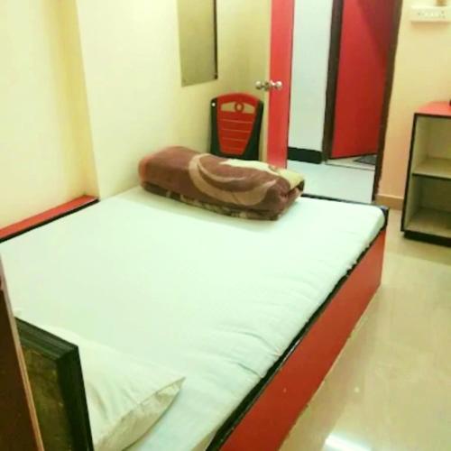 a room with a bed with a bag on it at Hotel Pine City in Shillong