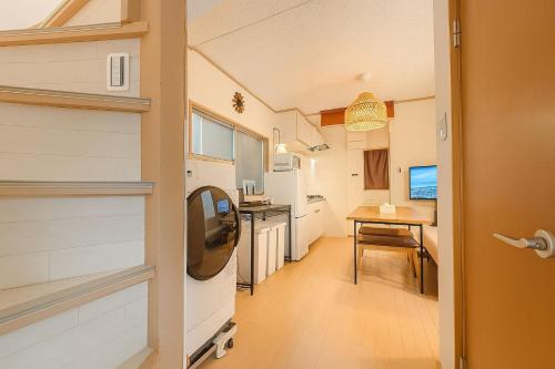 a small kitchen with a table and a door at shibuya sakaraku-SY0027 in Tokyo