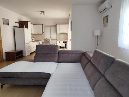 a living room with a couch and a kitchen at Apartments Marta in Seline