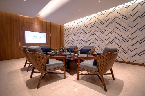 a dining room with a table and chairs at Novotel Bogor Golf Resort in Bogor