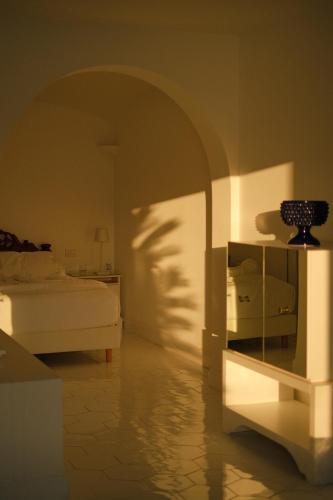 a bedroom with a bed and a table with a vase on it at Hotel Belair in Sorrento