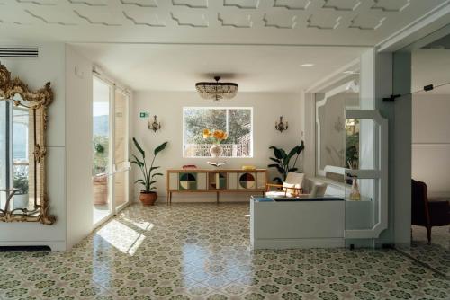 a living room with a table and a window at Hotel Belair in Sorrento