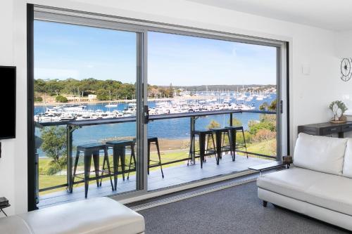 a living room with a view of a marina at Chilling Bayside Waterfront in Cronulla