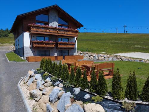 a house with a bench in front of it at Apartmány Dominek in Ždiar
