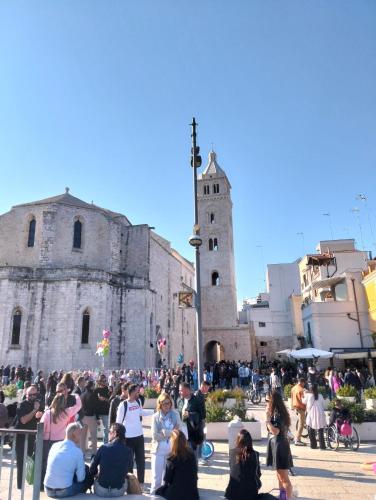 a crowd of people sitting in front of a building at Tina's House in Barletta