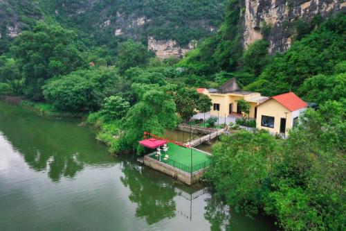 an aerial view of a house in the middle of a river at Tràng An Sunny River Homestay in Ninh Binh