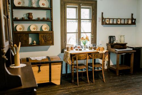 a dining room with a table and chairs and a window at Starodawna Chata - Dziad in Zamość