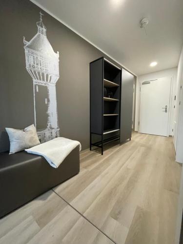 a room with a bed and a book shelf at Exklusives Wohnen im historischen Wasserturm dem Highlight von Delitzsch WE318 in Delitzsch