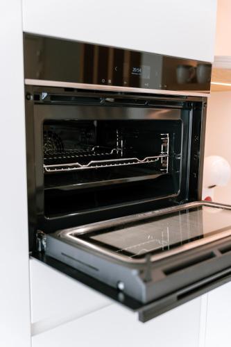 a microwave oven with its door open in a kitchen at La Brise Marine in Ostend