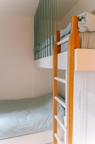 a bunk bed room with a ladder to a bunk bed at La Brise Marine in Ostend