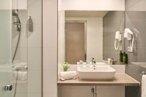 a white bathroom with a sink and a shower at Ona Marbella Inn in Marbella