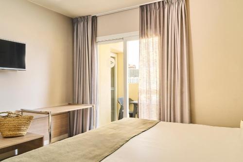 a hotel room with a bed and a window at Ona Marbella Inn in Marbella