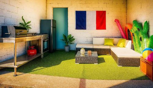 a living room with a couch and a table at Villa Perle Atlantique in La Vallée