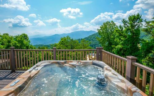 a hot tub on a deck with mountains in the background at Eagles Nest in Gatlinburg