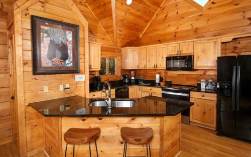 a kitchen with a large island in a wooden cabin at Eagles Nest in Gatlinburg