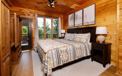 a bedroom with a bed and a window in a cabin at Eagles Nest in Gatlinburg