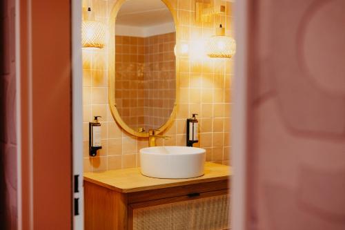 a bathroom with a sink and a mirror at Residhome Nanterre La Défense in Nanterre